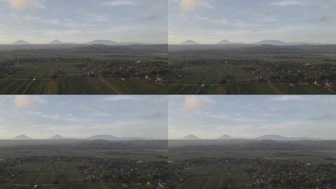 印度尼西亚的空中山靠近日出背景的村庄