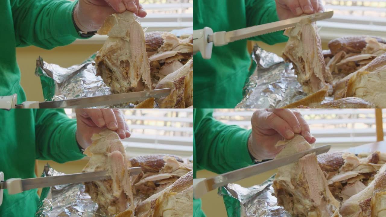用电刀为感恩节晚餐雕刻火鸡的白种人手的手持照片