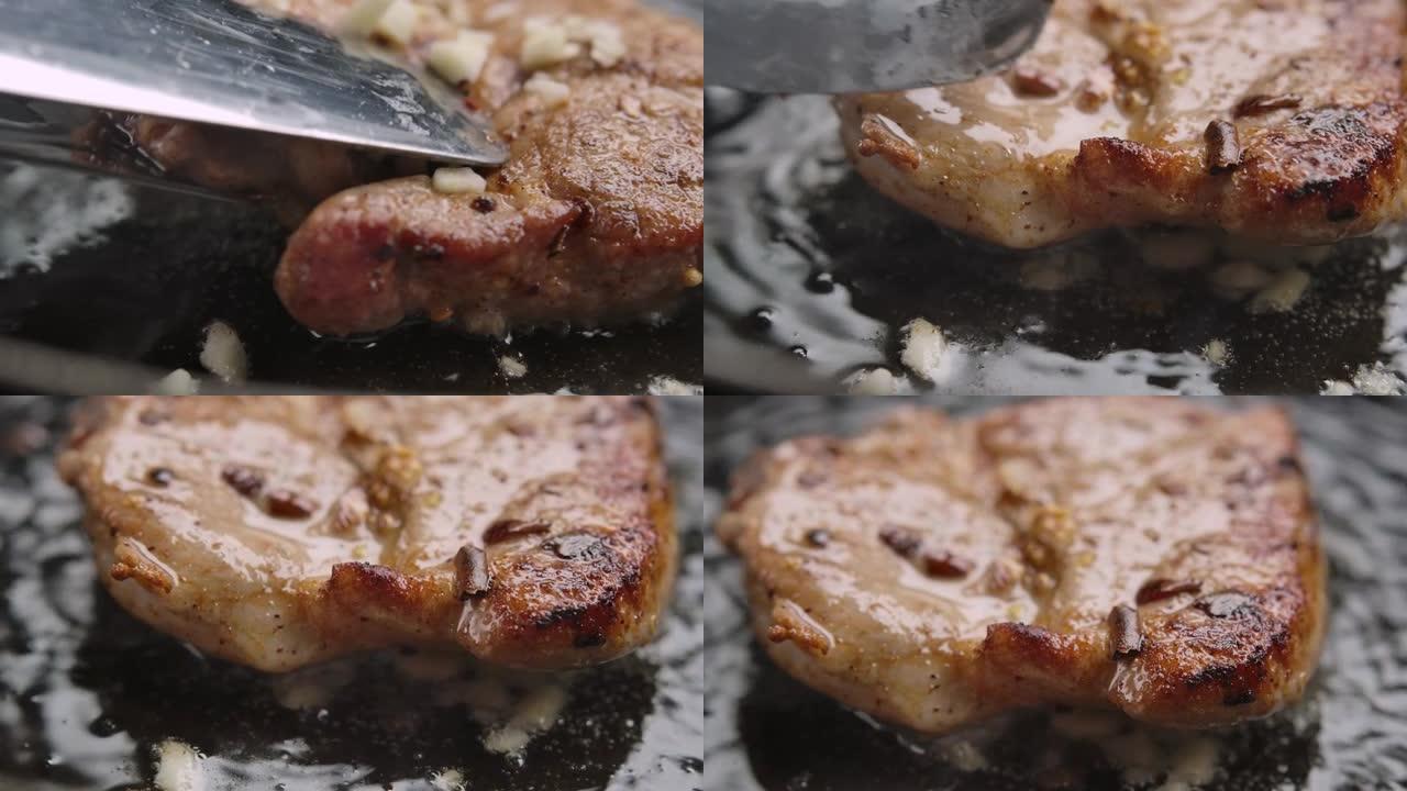厨房大钳旋转美味猪肉牛排的超级特写