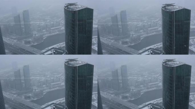 莫斯科市降雪。清晨在暴风雪中，现代办公楼商务中心的高层镜塔。国际商务中心