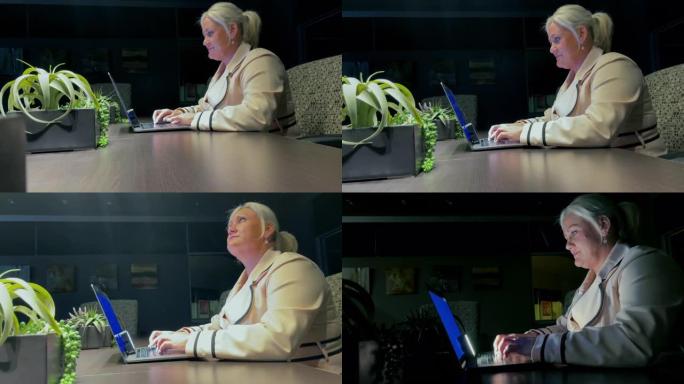 停电期间的成年女商人上班族在一个暴风雨的下雨的夜晚在笔记本电脑上工作4k视频系列