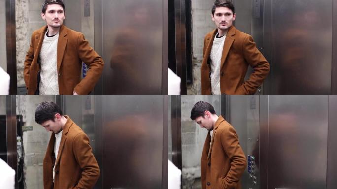 一个年轻时尚的家伙在电梯里站起来。
