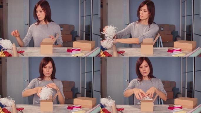 女人把工艺碎纸放在包装盒包装礼品中