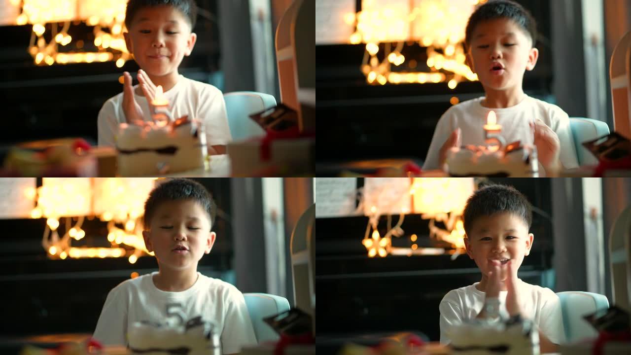 亚洲孩子带着他的生日蛋糕和礼物。庆祝和欢乐的概念