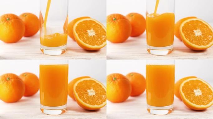 将新鲜的橙汁倒入白色厨房的玻璃杯中。健康营养，有机饮料。维生素c。增强免疫力。增强免疫系统。健康的生