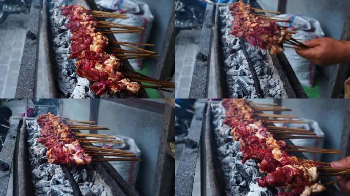 印度尼西亚中爪哇省萨拉蒂加的带竹扇的山羊沙爹烧烤。