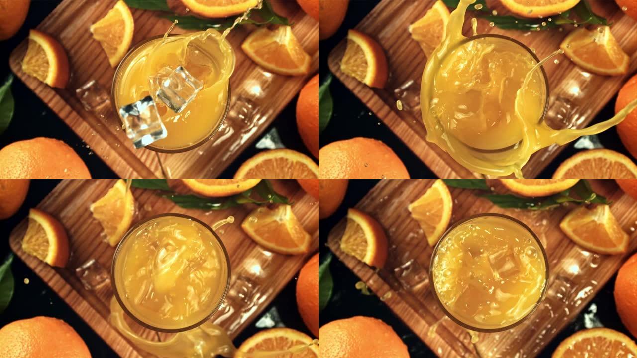 冰块溅入橙汁。拍摄的是每秒1000帧的慢动作。
