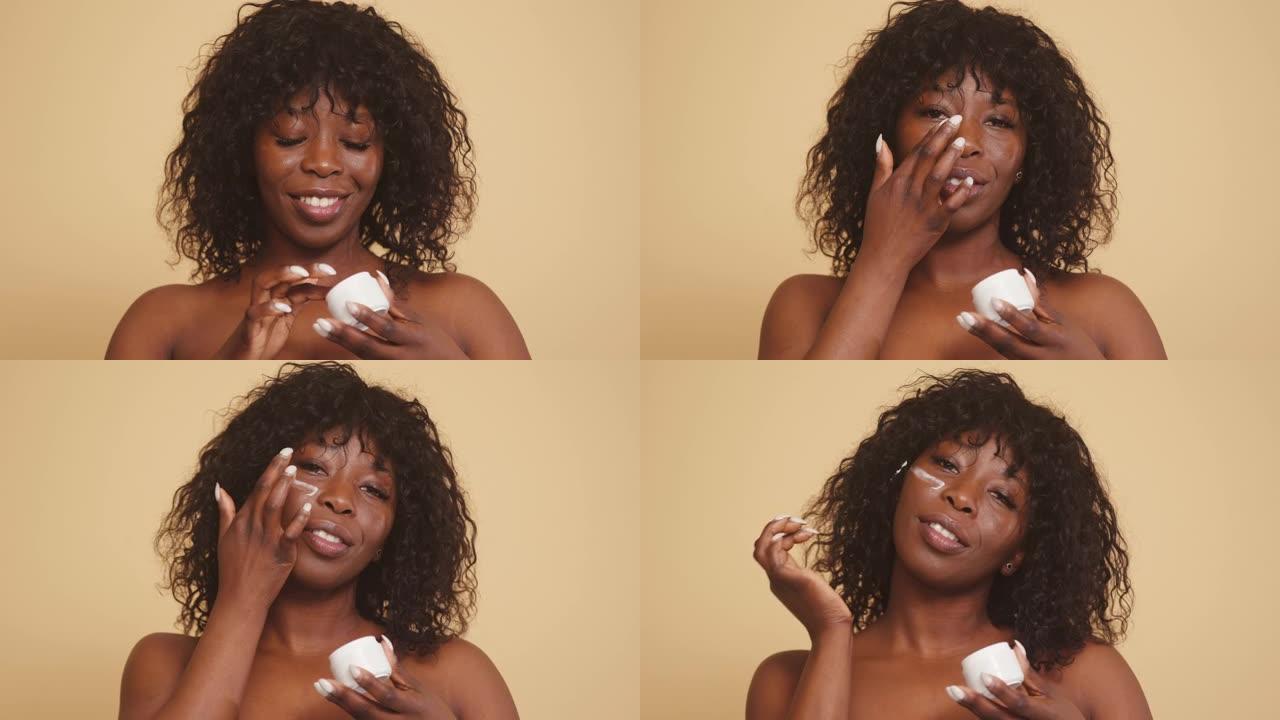 非裔美国妇女用面霜滋润皮肤