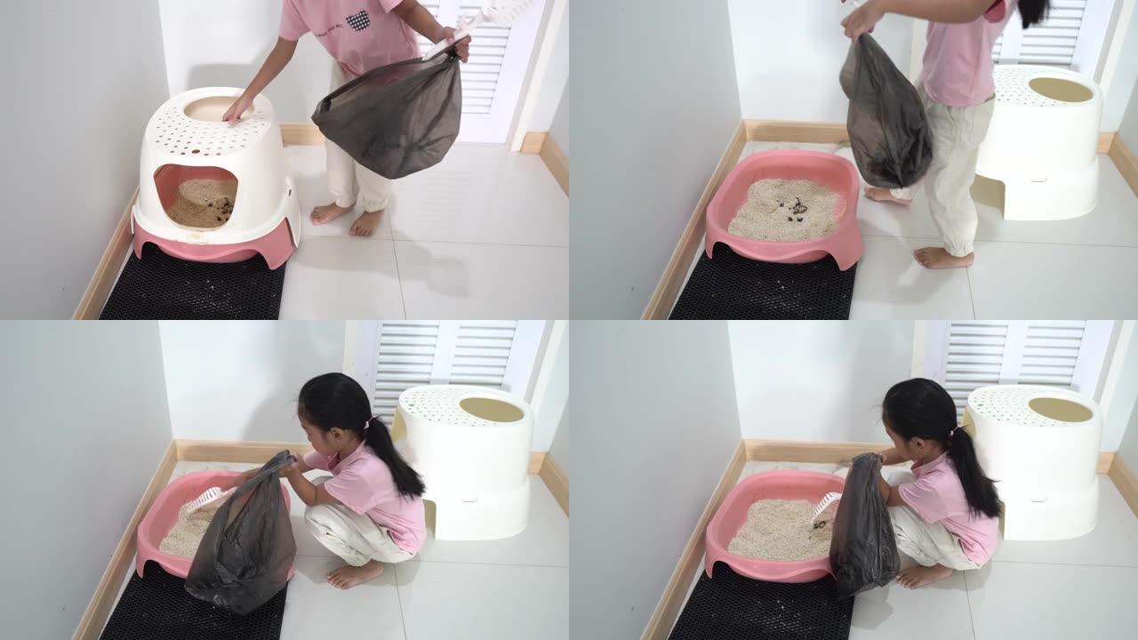 亚洲小女孩在家清洁猫砂托盘