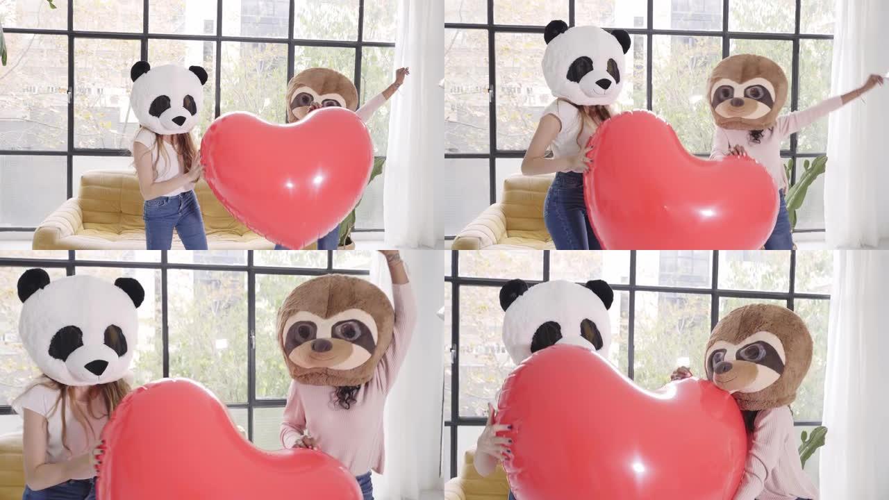 戴着动物面具的有趣女人熊熊猫抱着大心脏在家里跳舞-快乐的积极情绪人们在一起恋爱
