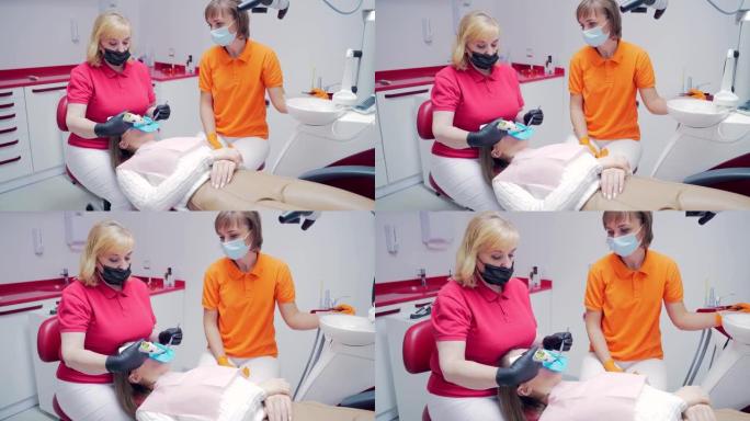 资深经验丰富的女牙医在牙科诊所用现代设备填充运河。通道的密封