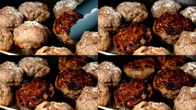 牛肉，羊肉，猪肉丸在煎锅中煎炸，用热油炒，然后用tong翻动。