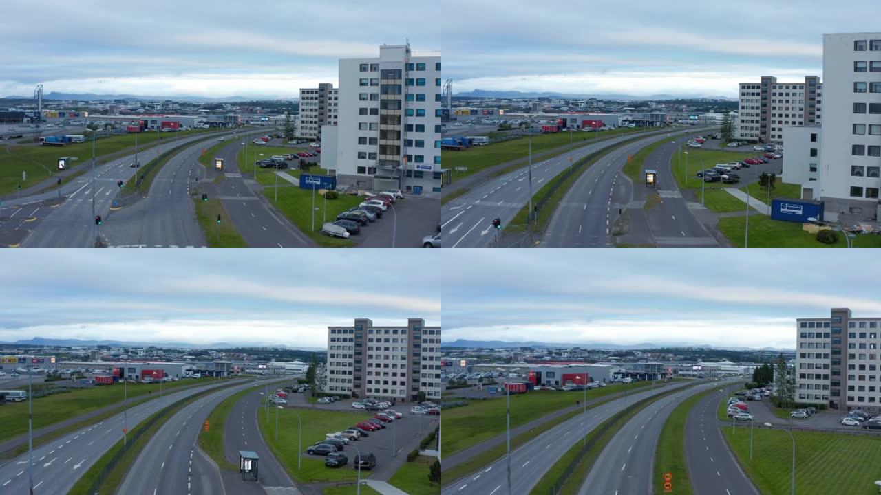 冰岛雷克雅未克繁忙高速公路的空中无人机视图。鸟瞰冰岛首都天际线，有邻里和商业区