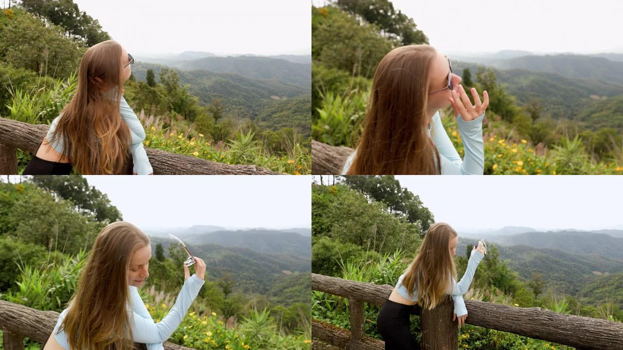 年轻的旅游女子可以从山上高处的木桥欣赏风景，该木桥设计用于从上方观看侧面。在丛林里。山的生动形象。旅