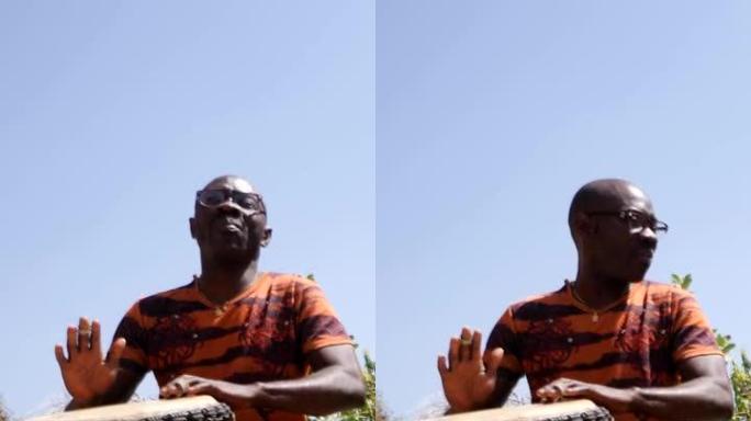 黑人与kenken和djembe一起扮演dunun的宽镜头的垂直视频