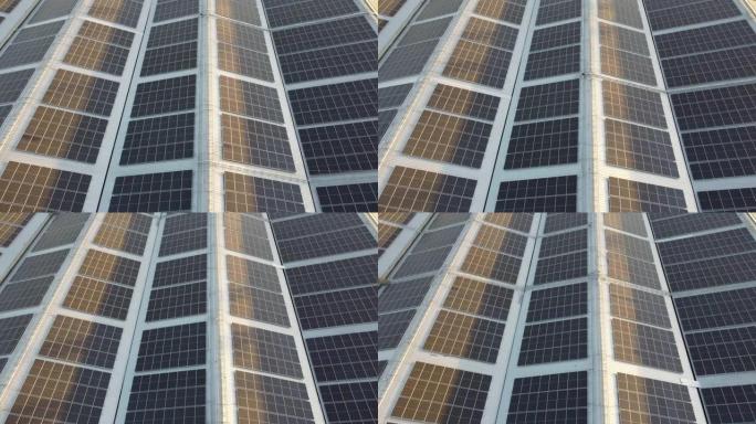 飞越大型工业工厂屋顶上的太阳能电池。太阳能屋顶正在为该行业产生可再生能源。目标是降低电力成本。