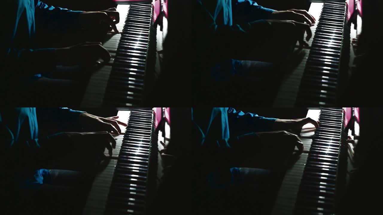 钢琴家在音乐会上在舞台上演奏美丽的三角钢琴。特写。男性手演奏三角钢琴的镜头。男人用手指触摸钥匙。