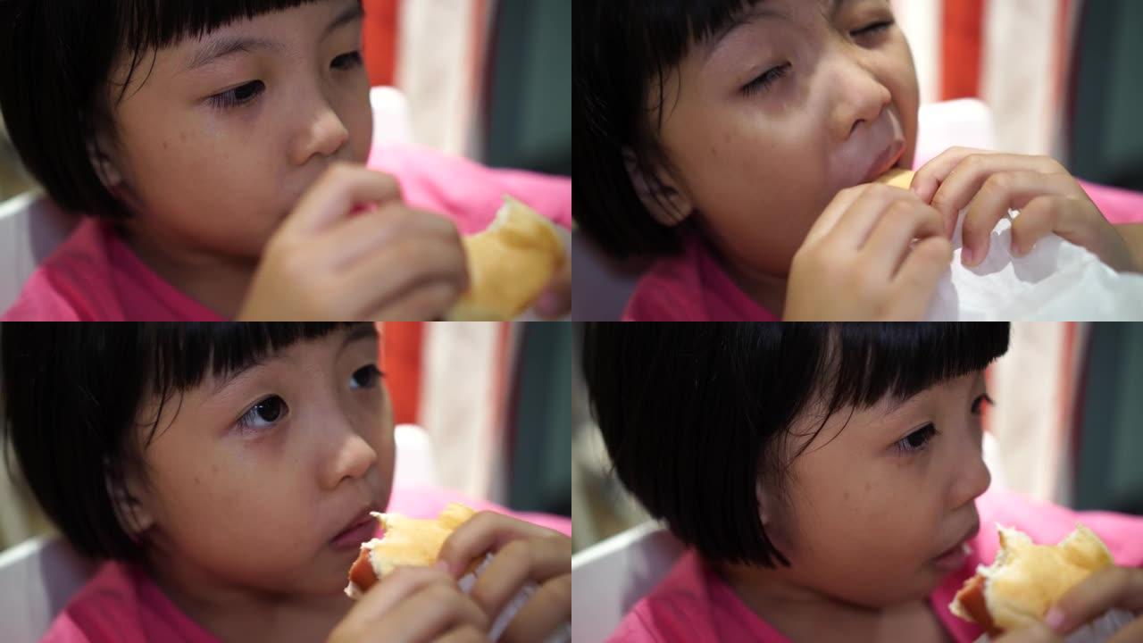 中国小女孩吃香肠。