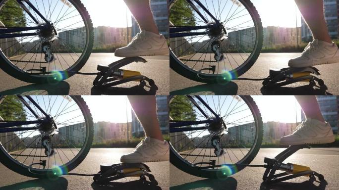 男子在户外给自行车轮胎充气。给自行车轮胎打气