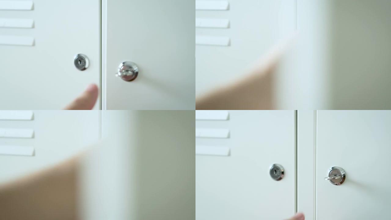 男人的手握着锁上柜门的钥匙。秘密存储概念