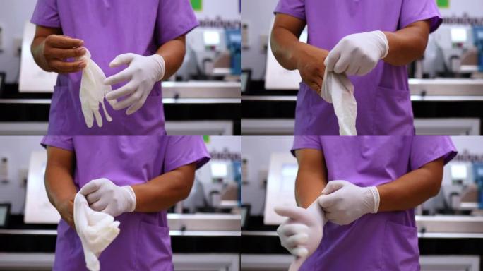 年轻兽医的手在实验室里放橡胶手套