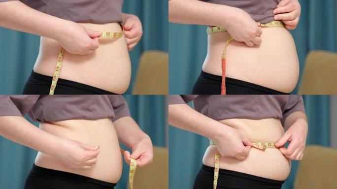 女人在公寓用磁带测量检查肚子