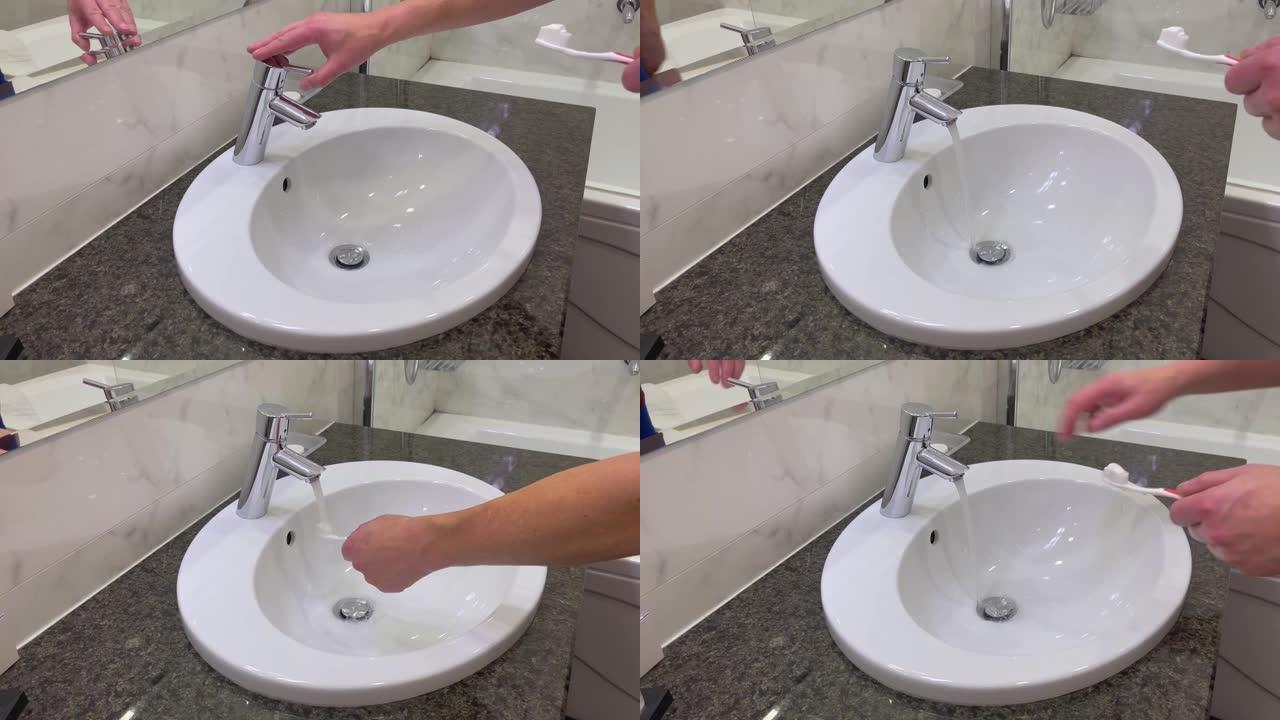 不露面的人手里拿着牙刷在盥洗台附近