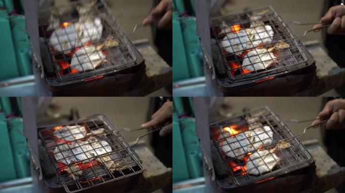 卖家准备干鱿鱼在泰国街头烧烤小吃著名的街头小吃木炭烤