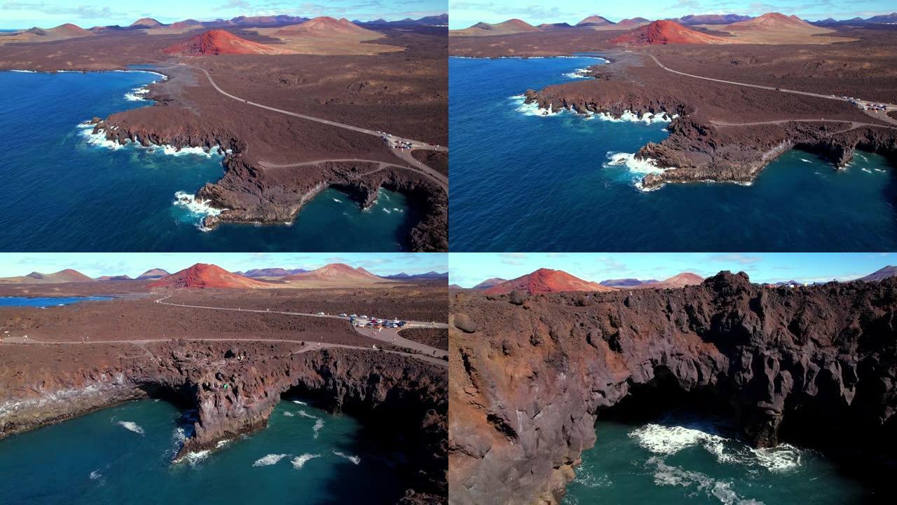 火山兰萨罗特岛风景。Los Hervideros洞穴，悬崖和红山的空中无人机视频。热门旅游目的地加那