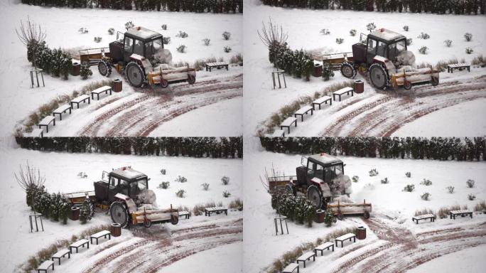 拖拉机用旋转刷子和扫雪机从桥上的行人专用区扫雪，暴风雪期间的人行道积雪管理。扫雪机服务清除道路上的冰