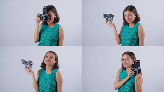 微笑的年轻开朗的印度女性拿着古董相机 & 拍照