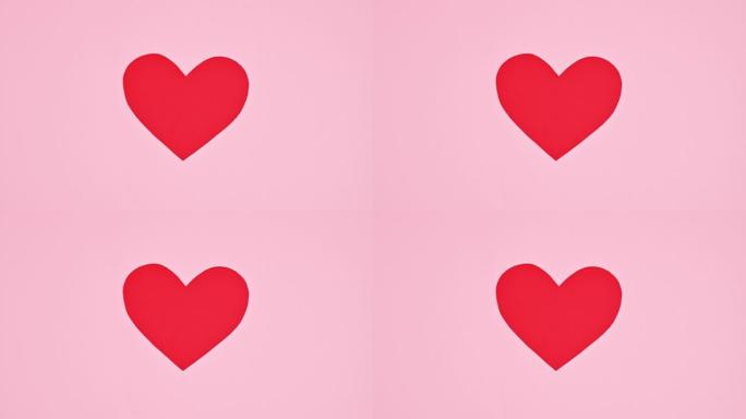 柔和的粉红色背景上的两颗心脏连接在一起。平躺。停止运动