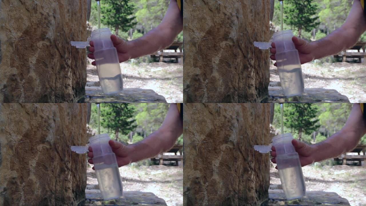 高清从山间喷泉倒瓶装水的特写镜头