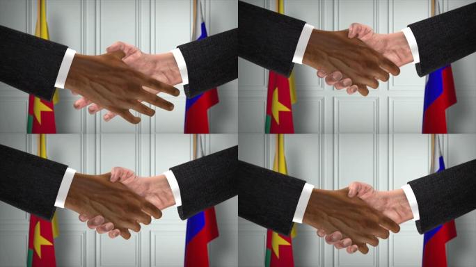 喀麦隆与俄罗斯交易握手，政治说明。正式会议或合作，商务见面。商人和政客握手