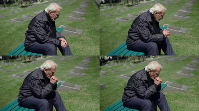 悲伤的白发老人坐在墓地，悲伤和悲伤的失去了亲密的人，4k 60p Prores