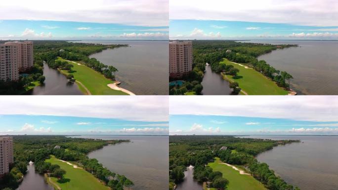 无人机鸟瞰图飞过佛罗里达州德斯廷的一个水上公寓，毗邻中湾大桥。