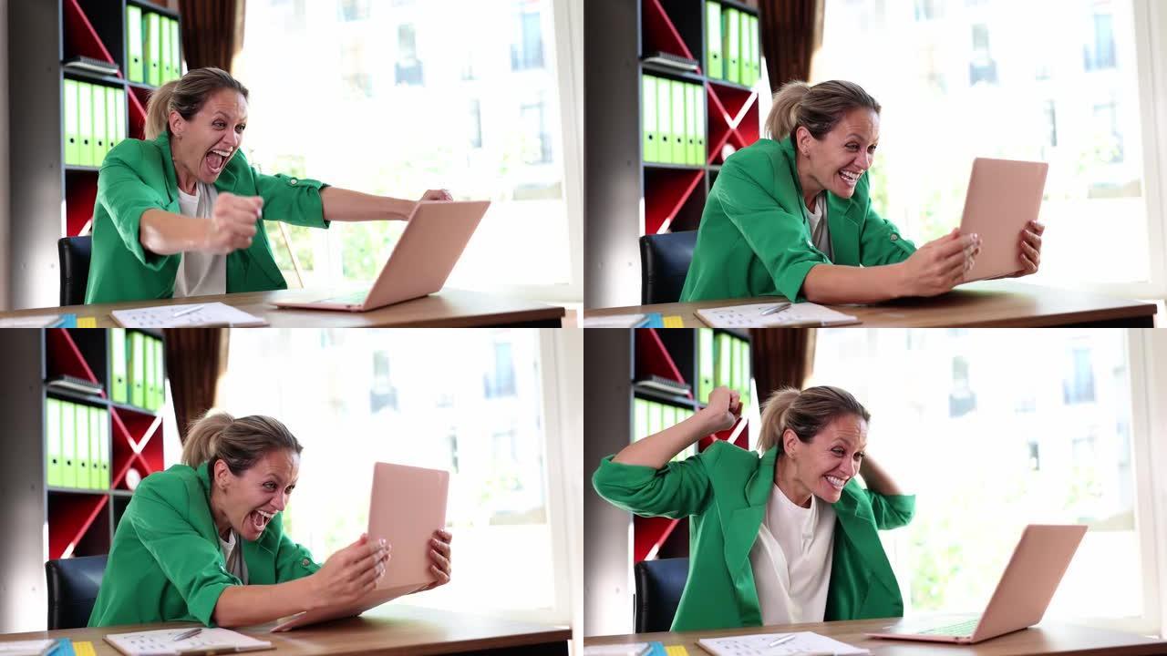 兴奋的女性用户，笔记本电脑在办公室获得惊人的销售优惠
