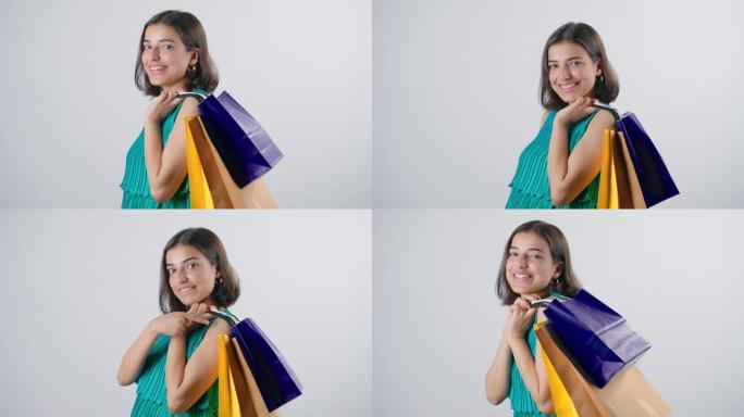 年轻开朗的印度妇女肩上扛着五颜六色的购物袋