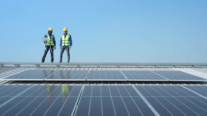 两名负责太阳能电池板安装的工程师目前正在调查将太阳能转换为仓库的电力的安装。