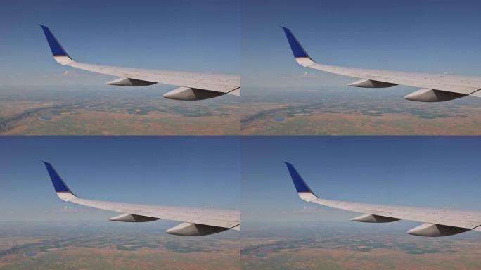 在背景中，您可以看到飞机机翼飞机在蓬松的多云天空上方飞行，就像通过地球上敞开的窗户看到的那样。