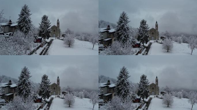 意大利皮亚琴察韦尔纳斯卡城堡上空的冬季暴风雪，被积雪覆盖，当地教区的无人机航拍视频