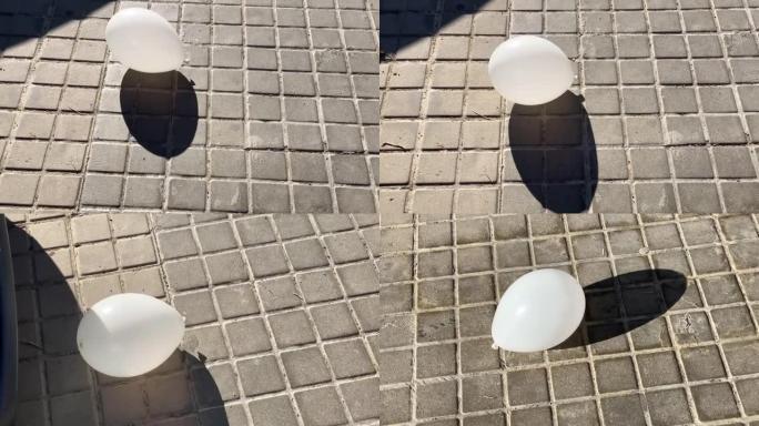 白色气球在人行道上弹跳