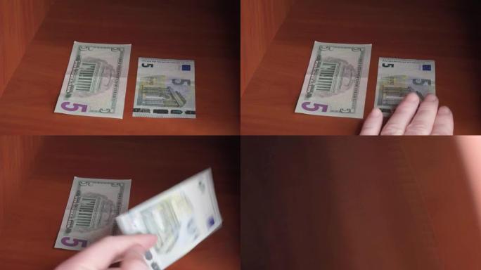 一个人的手选择取哪一张钞票，美元还是欧元。她选择欧元，把美元留在壁橱里。