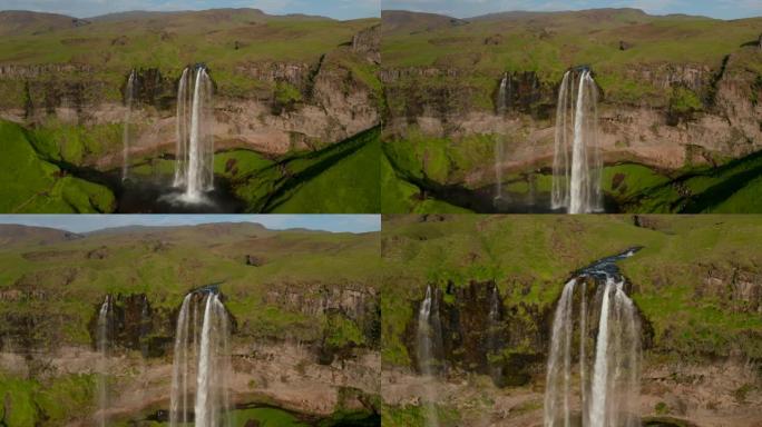 美丽风景中高大的塞尔贾兰德斯福斯瀑布的航拍画面。向前飞行超过自然吸引力。冰岛塞尔贾兰德斯福斯瀑布