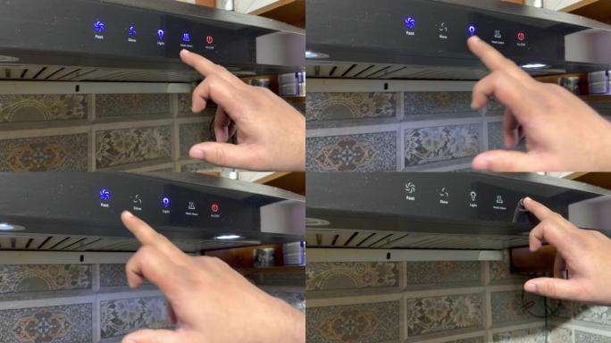 现代厨房概念。在现代厨房中，手指触摸按钮打开厨房引擎盖的特写镜头。现代厨房中的技术