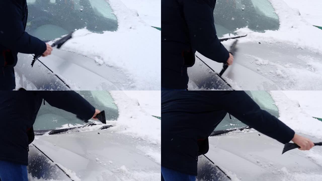 冬天降雪的人扫除了汽车上的雪。慢动作。