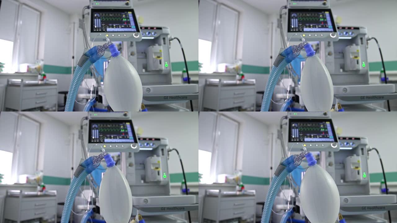 膨胀的ambu袋挂在手术室。模糊背景下肺部呼吸机的生命迹象屏幕。