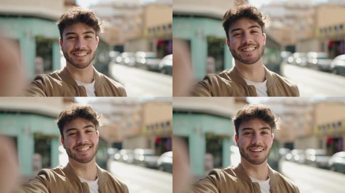 年轻的西班牙裔男子微笑着自信地在街上进行视频通话