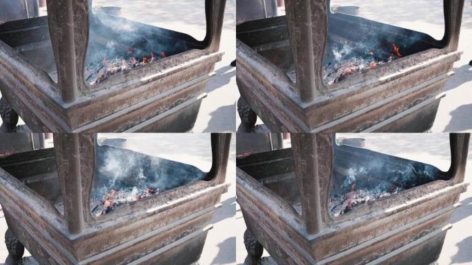 中国传统寺庙青铜香炉烧香，灰烬和烟在风中飞翔，4k慢镜头，宗教概念。