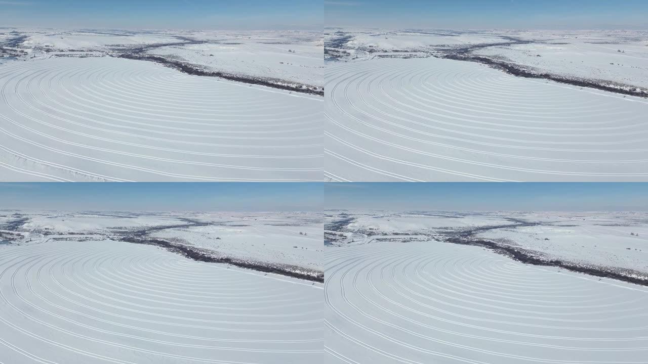 田地上冰雪表面曲线的航拍镜头，融化作业